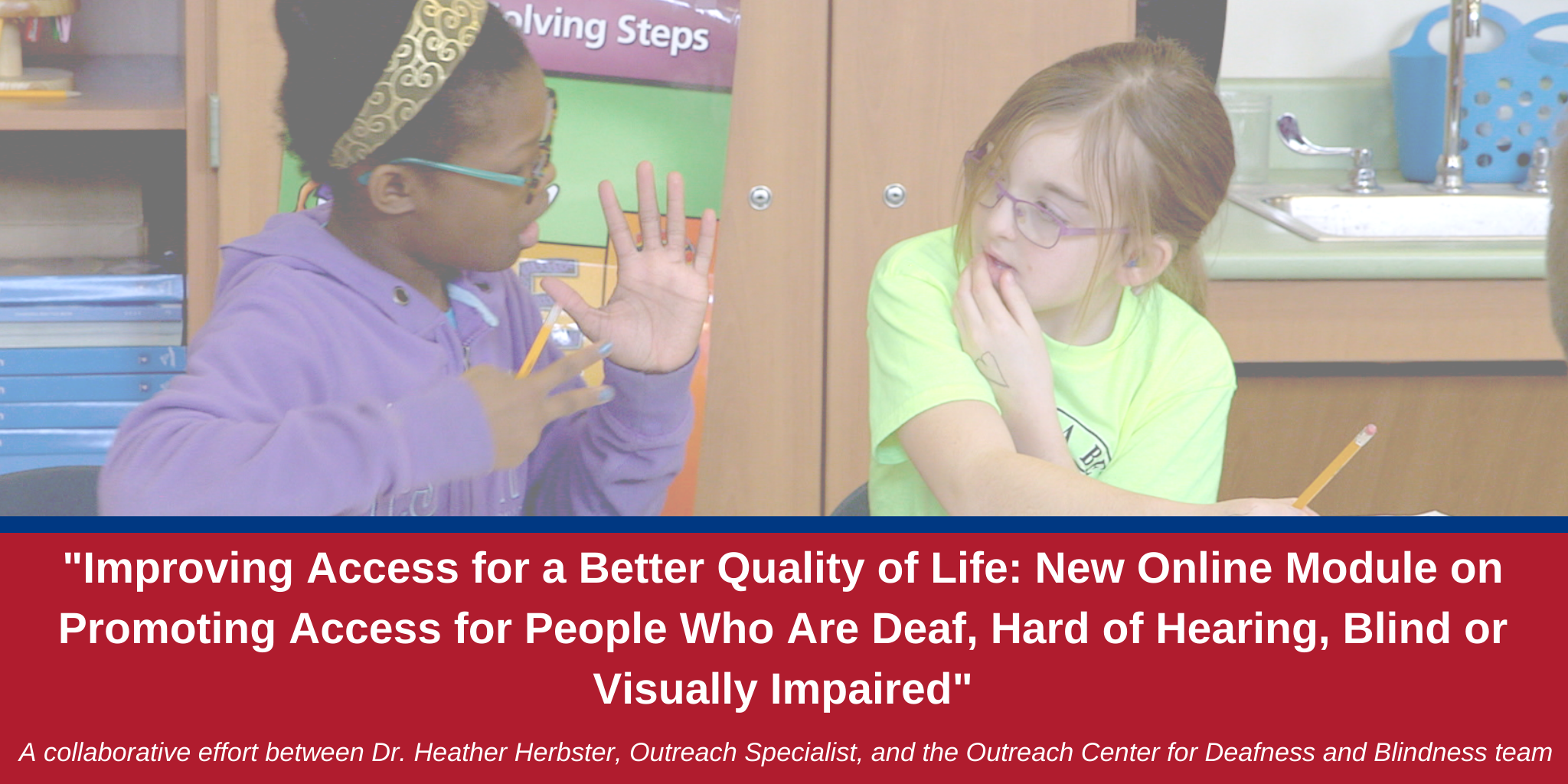 African American and caucasian young girls signing to each other while sitting at a classroom desk