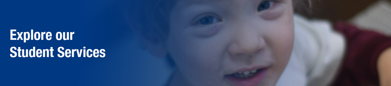 young boy looking at camera smiling. blue gradient with white text: "Explore our Student Services"